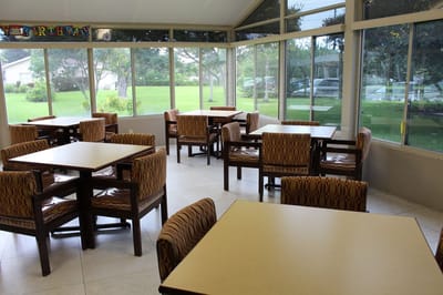 Bright common area with dining tables and chairs