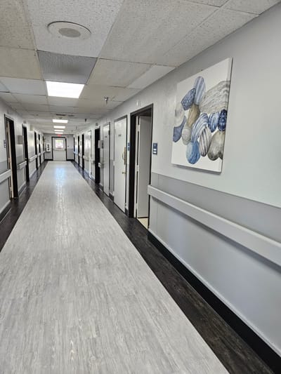 Bright hallway with artwork and resident rooms