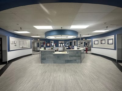 Interior lobby area with reception desk and staff
