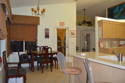 Common area with dining table and kitchen