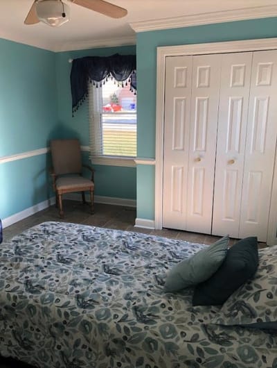Cozy resident room with blue walls and floral bedding