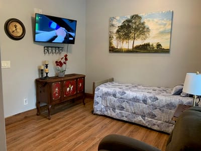 Cozy resident room with a bed and television