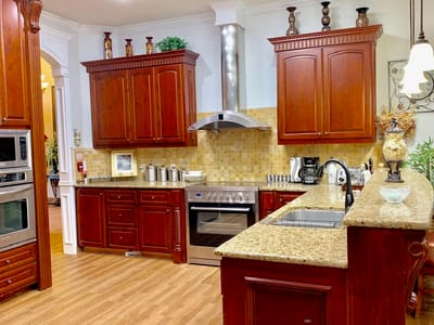 Well-equipped kitchen with wooden cabinets and granite countertops