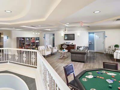 Bright common area with seating and a gaming table
