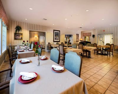 Dining area with set tables and floral arrangements