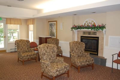 Cozy interior common area with chairs and a fireplace
