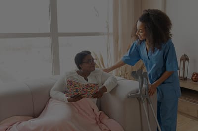 A nurse assisting a resident in a cozy living space