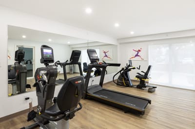 Well-equipped fitness room with exercise machines