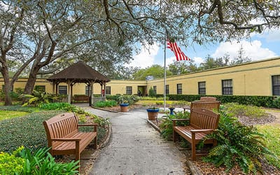 Pathway with benches and gazebo in a garden setting