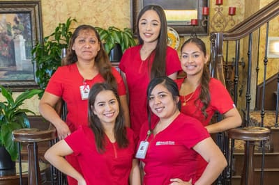 Staff members posing in a welcoming facility lobby