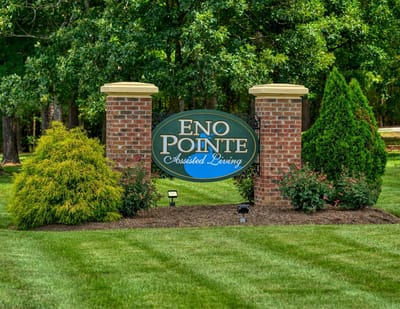 Entrance sign of Eno Pointe Assisted Living surrounded by landscaping