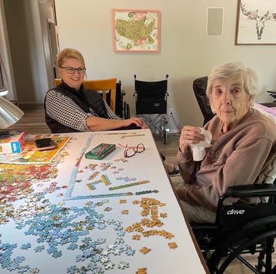 Residents engaged in a puzzle activity in a common area
