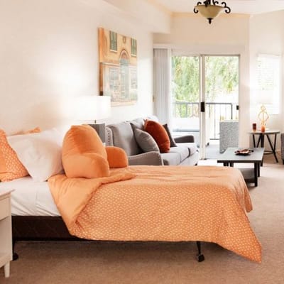 A well-furnished resident room with natural lighting