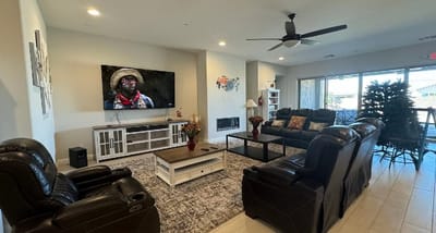 Bright common area with couches and a TV.