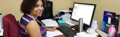 Staff member working at a desk with a computer