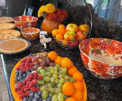 A variety of fruits and desserts displayed on a table