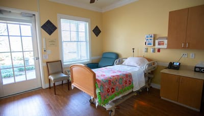 Private resident room with bed and chair