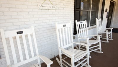 Rocking chairs on a porch outside the pavilion