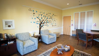 Cozy common area with seated furniture and wall art