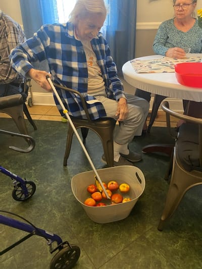 Residents engaged in an activity with apples.