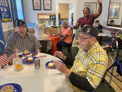 Residents enjoying a festive gathering with donuts