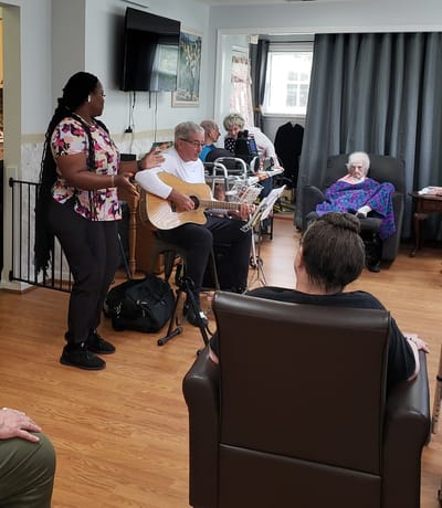 Residents enjoying live music in a common area