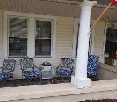 Outdoor seating area with chairs and flowers