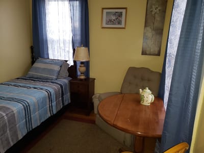Cozy resident room with a bed and seating area