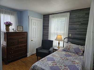 Cozy private resident room with bed and dresser