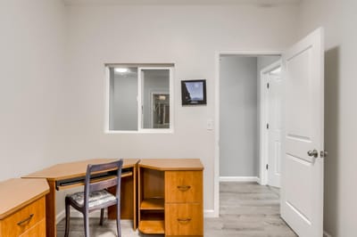 A private room with a desk and chair