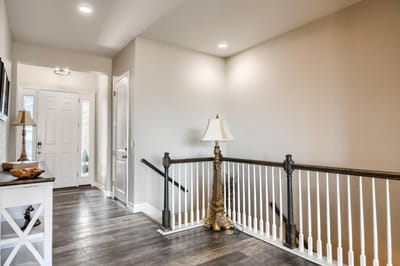 A hallway in an assisted living facility with a lamp and decor
