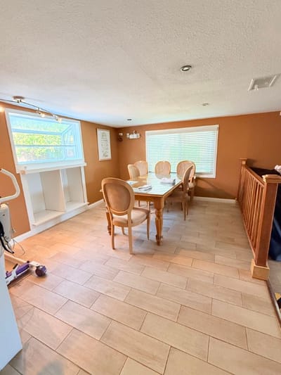 Bright common area with dining table and chairs