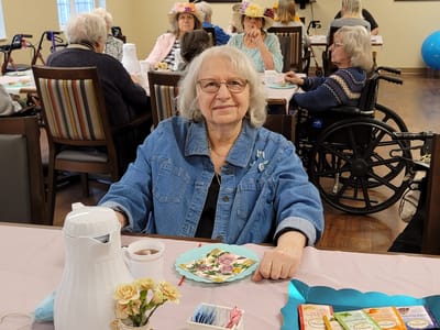 Resident enjoying a meal in the dining room