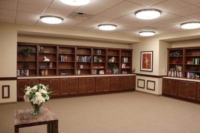 Cozy reading area with bookshelves and floral arrangement