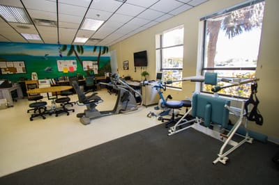 Interior view of a therapy room with fitness equipment