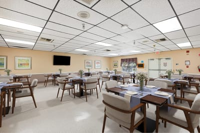 Bright dining room with tables set for meals