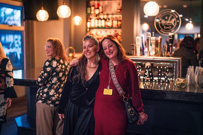 Two staff members smiling in a social setting