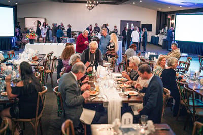 Residents dining and socializing at a large event