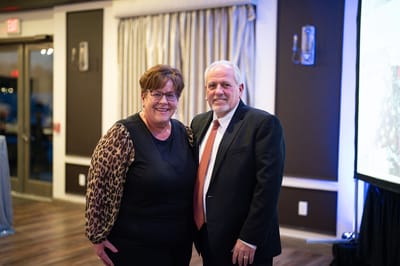 Two people posing at a facility event