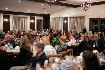 Crowd of people enjoying an event in a dining area