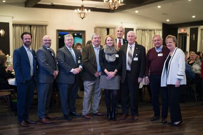 A group of people posing together at a facility event