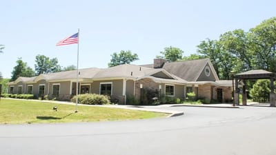 Exterior view of the hospice residence with flag
