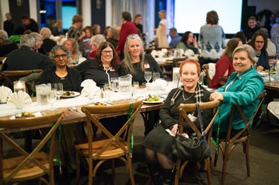 Residents and staff enjoying a community dinner event