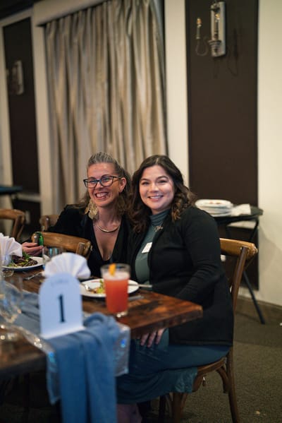 Two women enjoying a meal in a dining setting