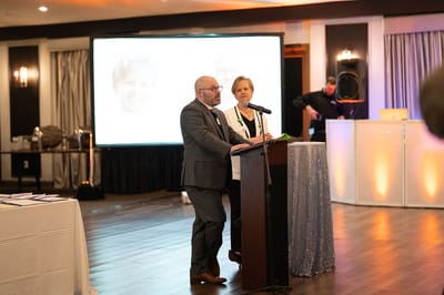 Two speakers addressing an audience at a community event