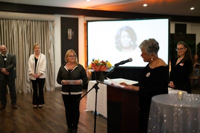 Residents and staff at an awards ceremony in a warmly lit room