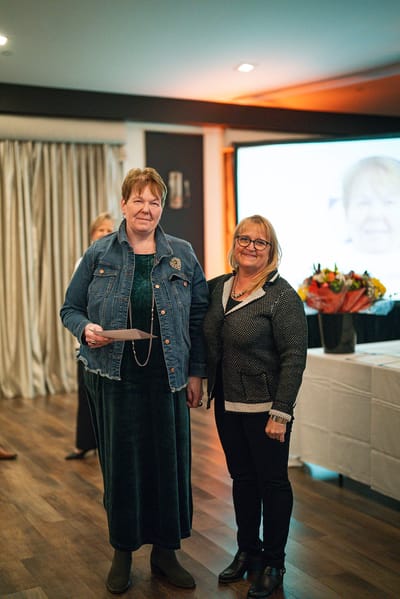 Two women at an event holding a certificate