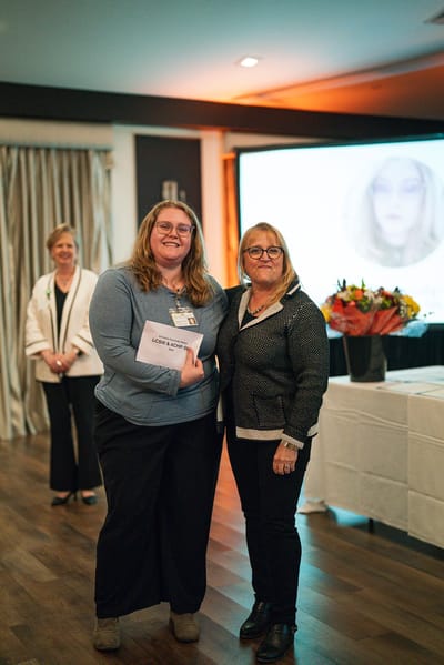 Staff member receiving an award at a celebration event