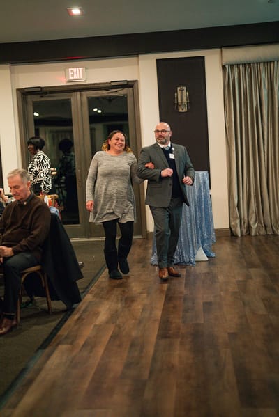 Two people walking in a common area during an event