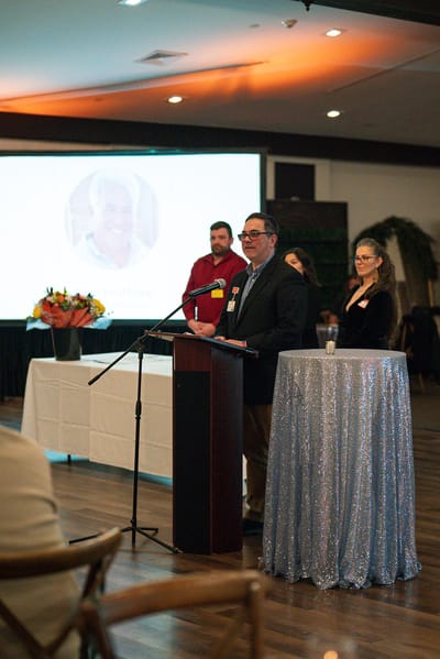 Speaker presenting at a community event with audience members